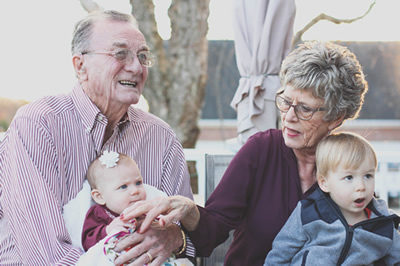 Two seniors enjoy time with their grandkids
