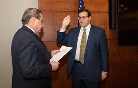 Dillon E. Breen raises his right hand as he gets sworn in as a trustee