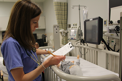 A student studying in the health simulation lab