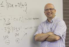  Brad Stetson in classroom in front of whiteboard with math equations