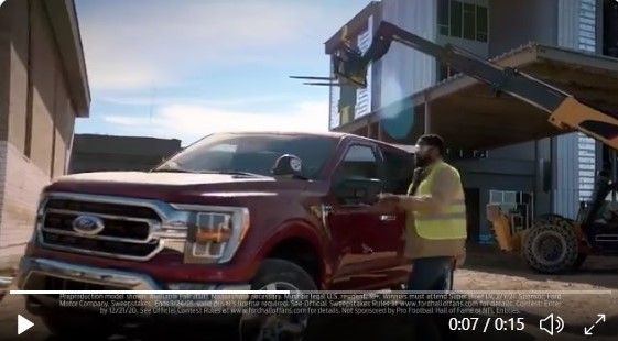 A male construction worker getting into a Ford truck at a construction site