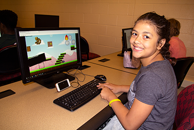 A young female learns gaming at a Kids off Campus class