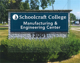 An outdoor blue sign with white text reading Manufacturing and Engineering Center