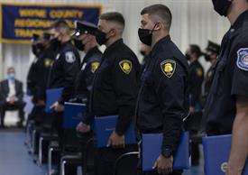 Students of the Police Academy standing during graduation ceremony