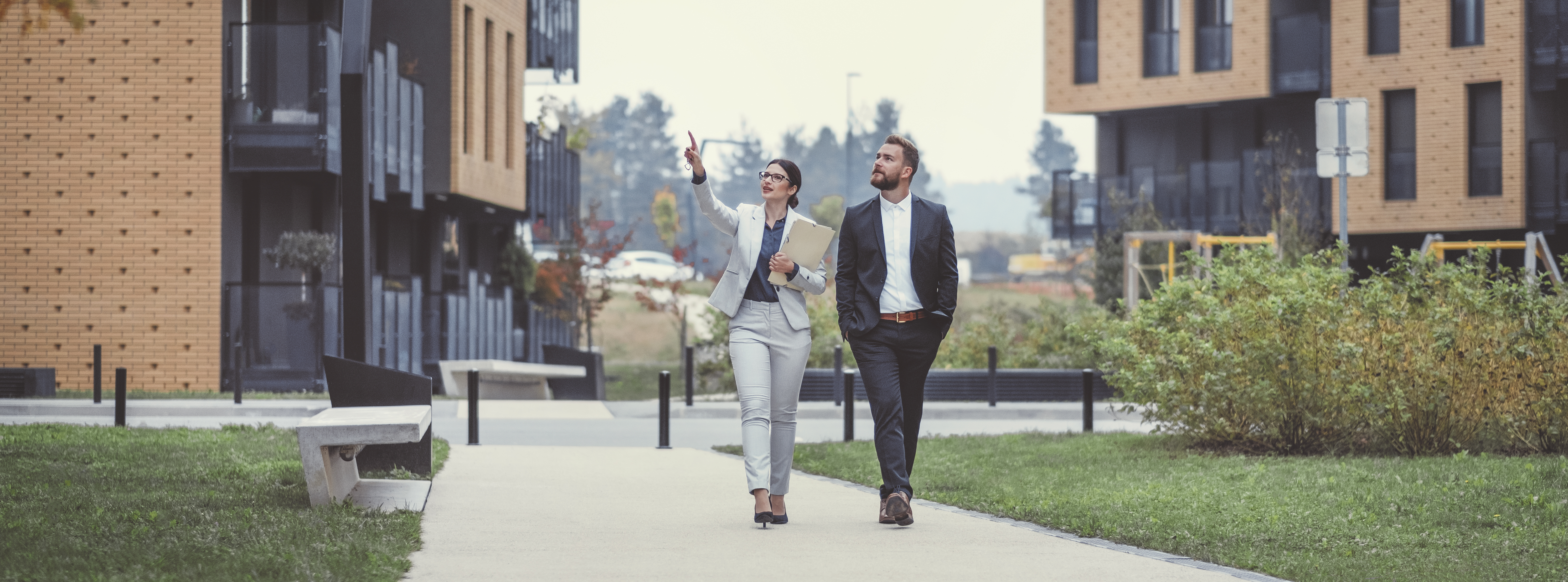 Two business people observing buildings